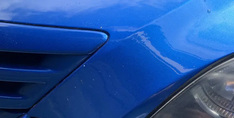 Originally dented blue car with dent removed