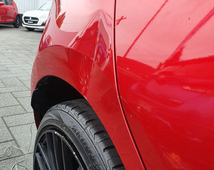 Red car with dent
