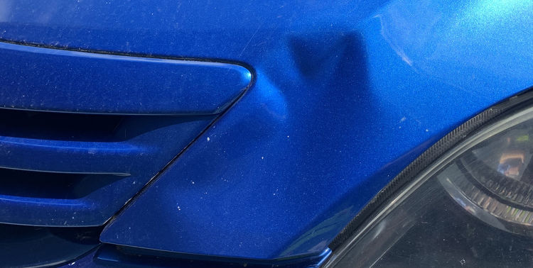 dented blue car